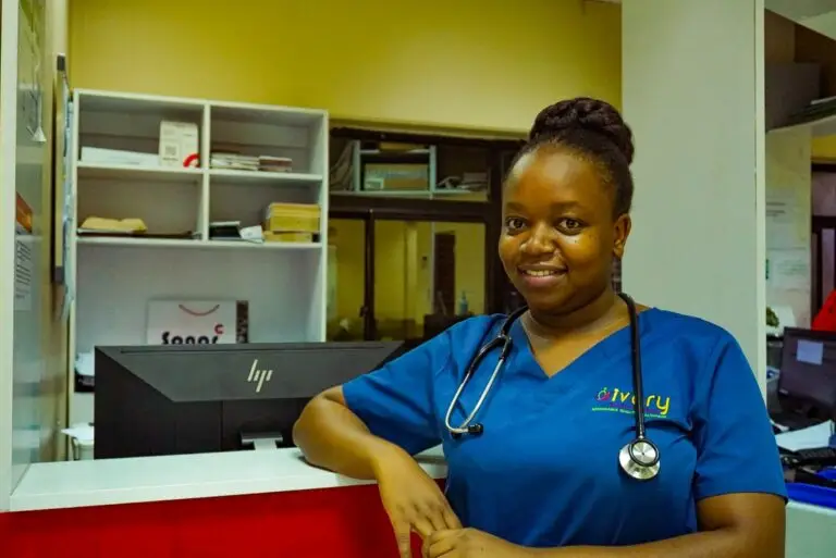 a woman wearing a blue scrubs and a stethoscope